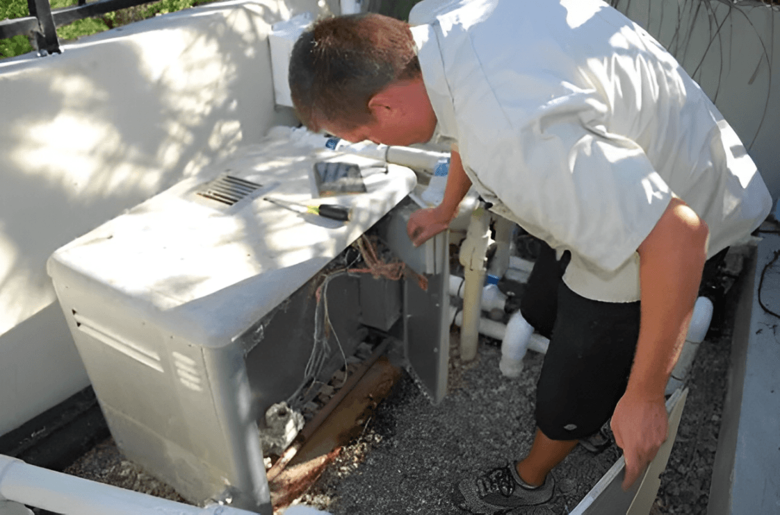 A professional pool technician inspecting a swimming pool heater for repairs.